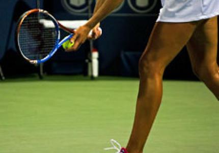 Tennis player readying serve